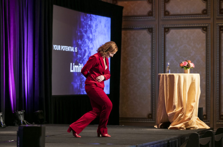 Tricia Brouk on stage does a walk down bow